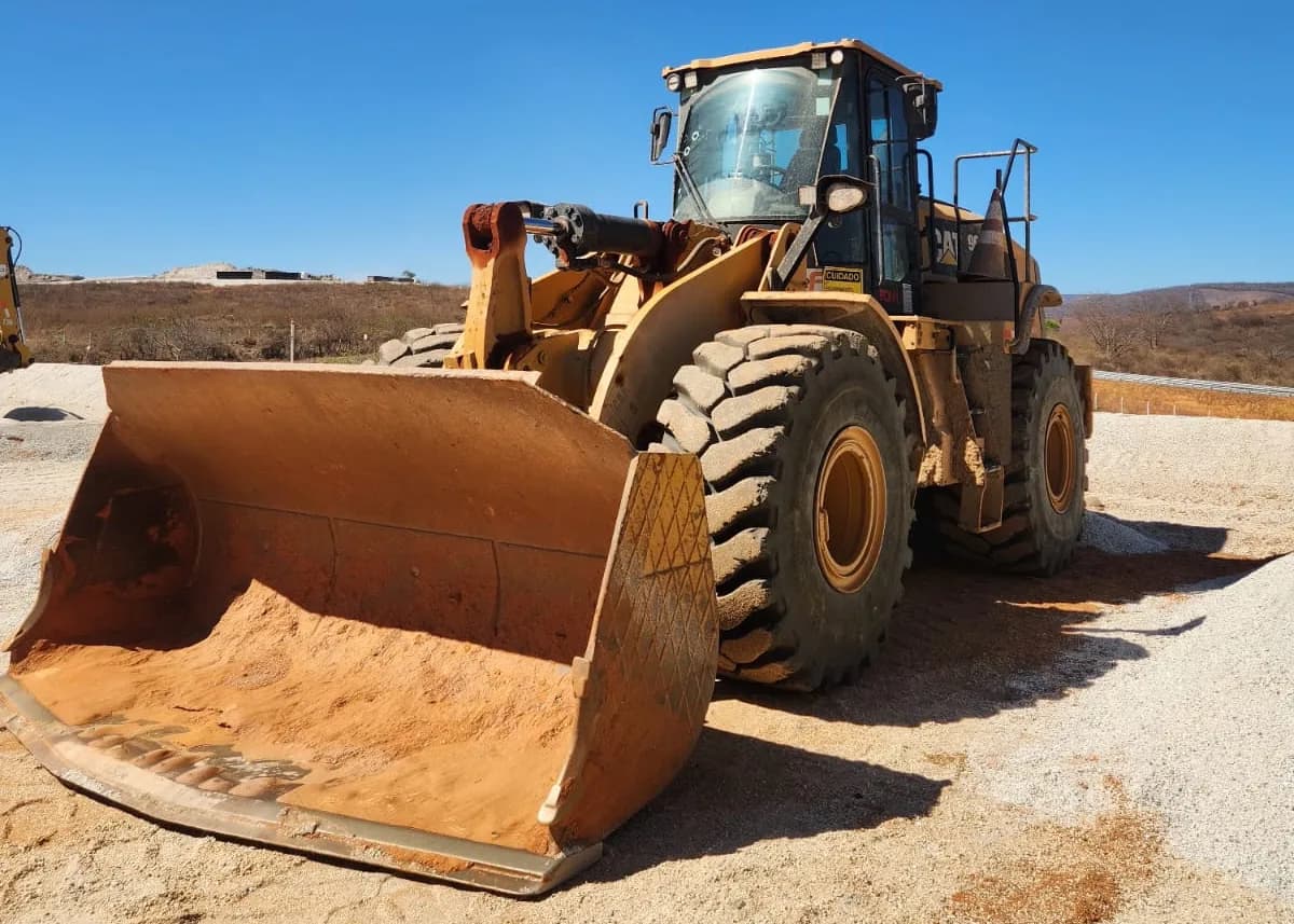Pá carregadeira Caterpillar com a caçamba apoiada no solo